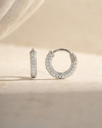 Close-up of 12mm sterling silver pavé hoop earrings by Sami Jewels, showcasing sparkling tiny stones and sleek hoop design.