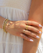 Gold Sami Jewels Pavé Link Ring stacked with diamond accents, showcasing intricate pave detailing on a stylish ring.