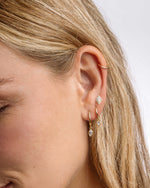 Sterling silver Halo Marquise Stud Earrings with pave detailing, shown stacked on a model's ear. Sami Jewels jewelry.