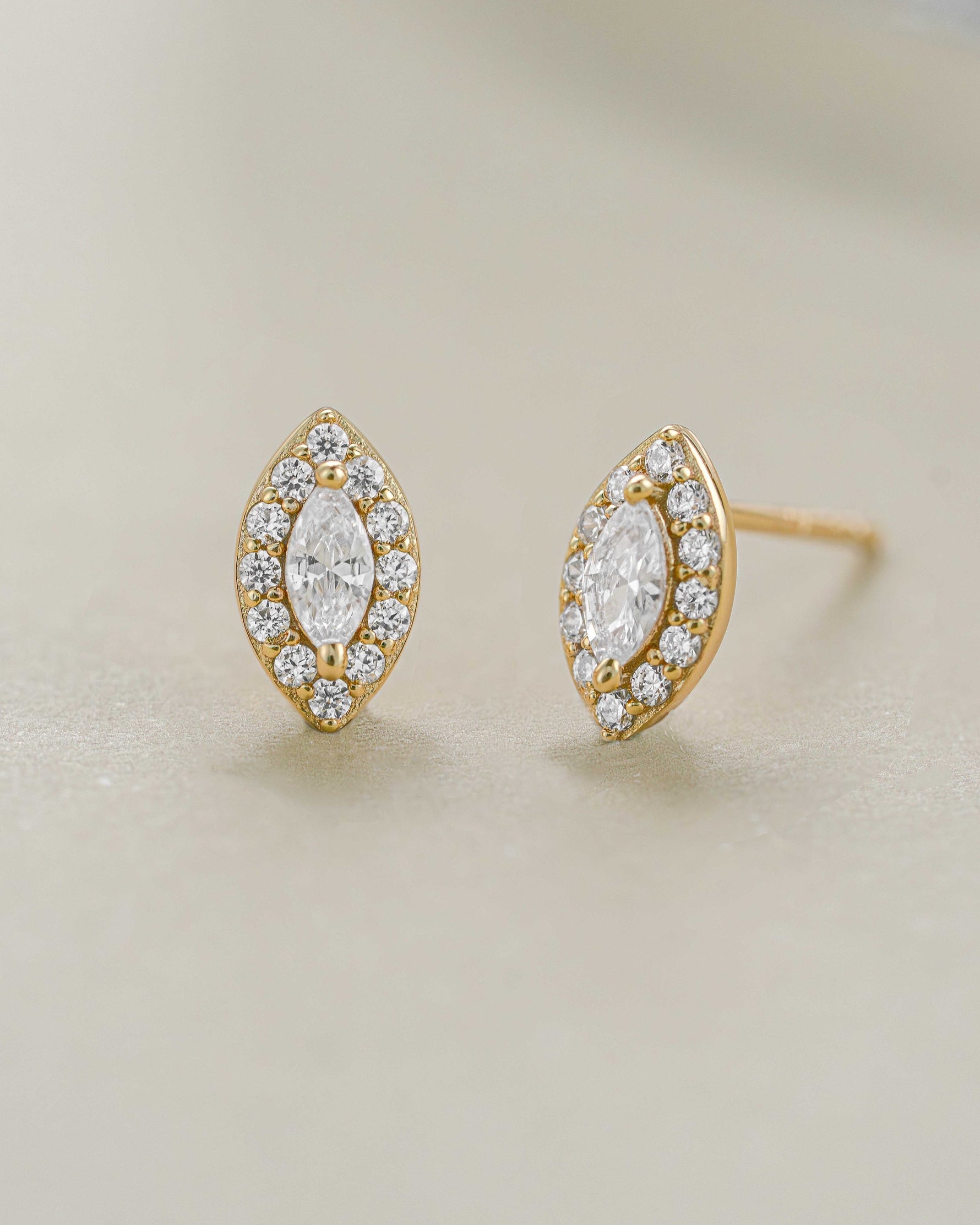 Close-up of gold Halo Marquise Stud Earrings by Sami Jewels featuring pave detailing and elegant marquise shape.
