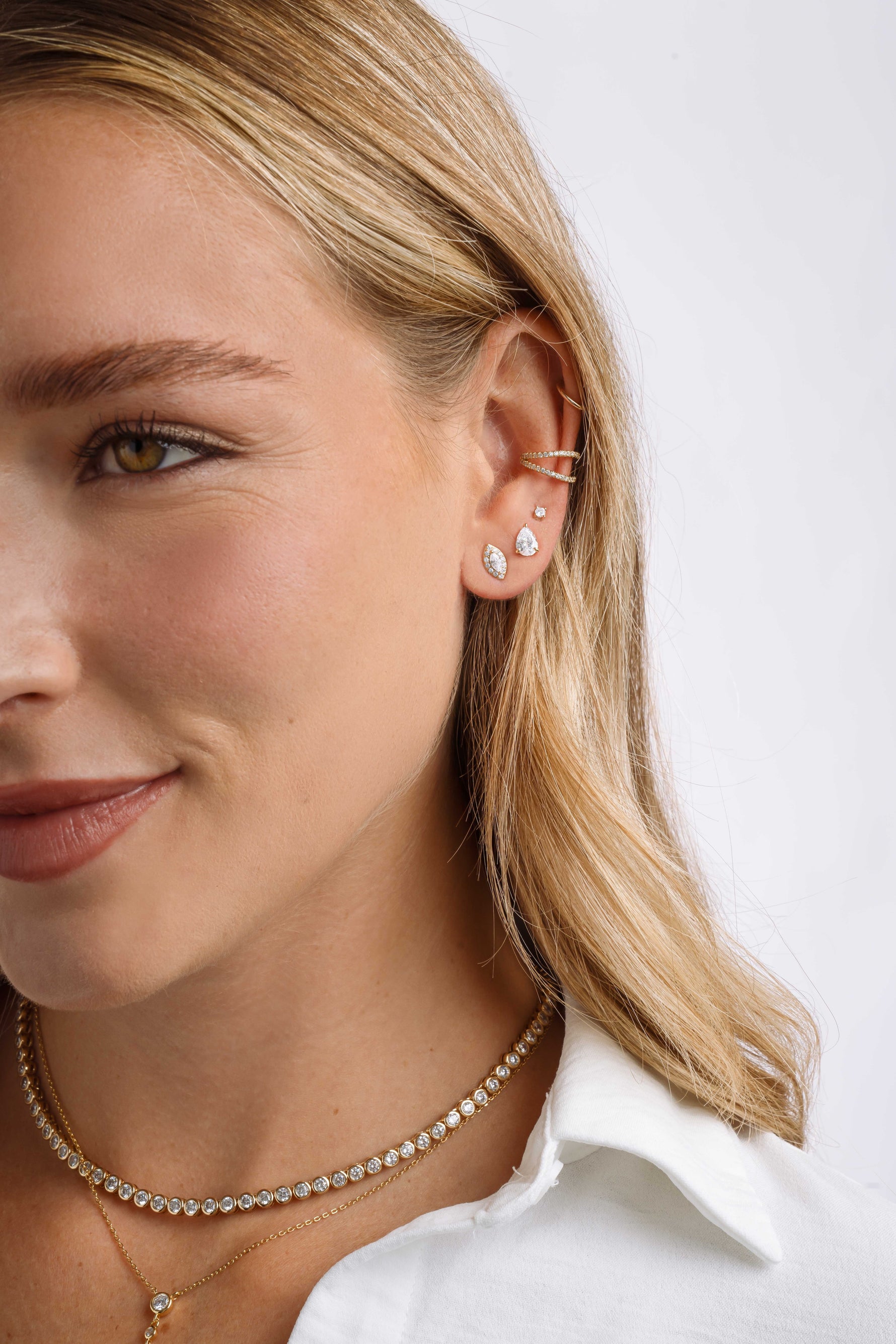 Sterling silver Halo Marquise Stud Earrings with pave detailing by Sami Jewels, shown on a model.