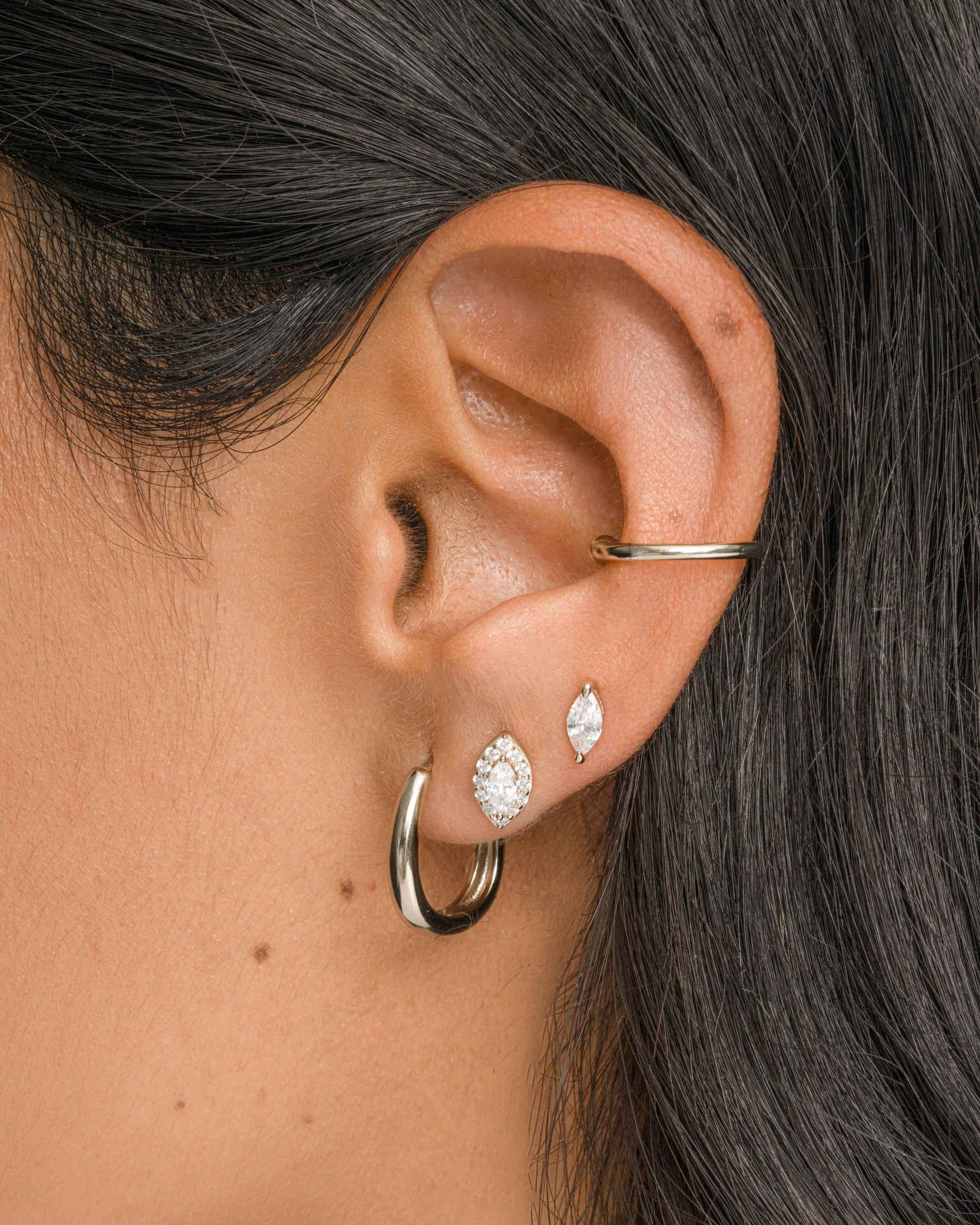 Sterling silver Halo Marquise Stud Earrings by Sami Jewels modeled on a person, showcasing elegant pave design.