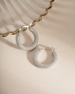 Close-up of sterling silver Pavé Tube Hoops earrings by Sami Jewels, showcasing their sparkling pave design and sleek hoop shape.