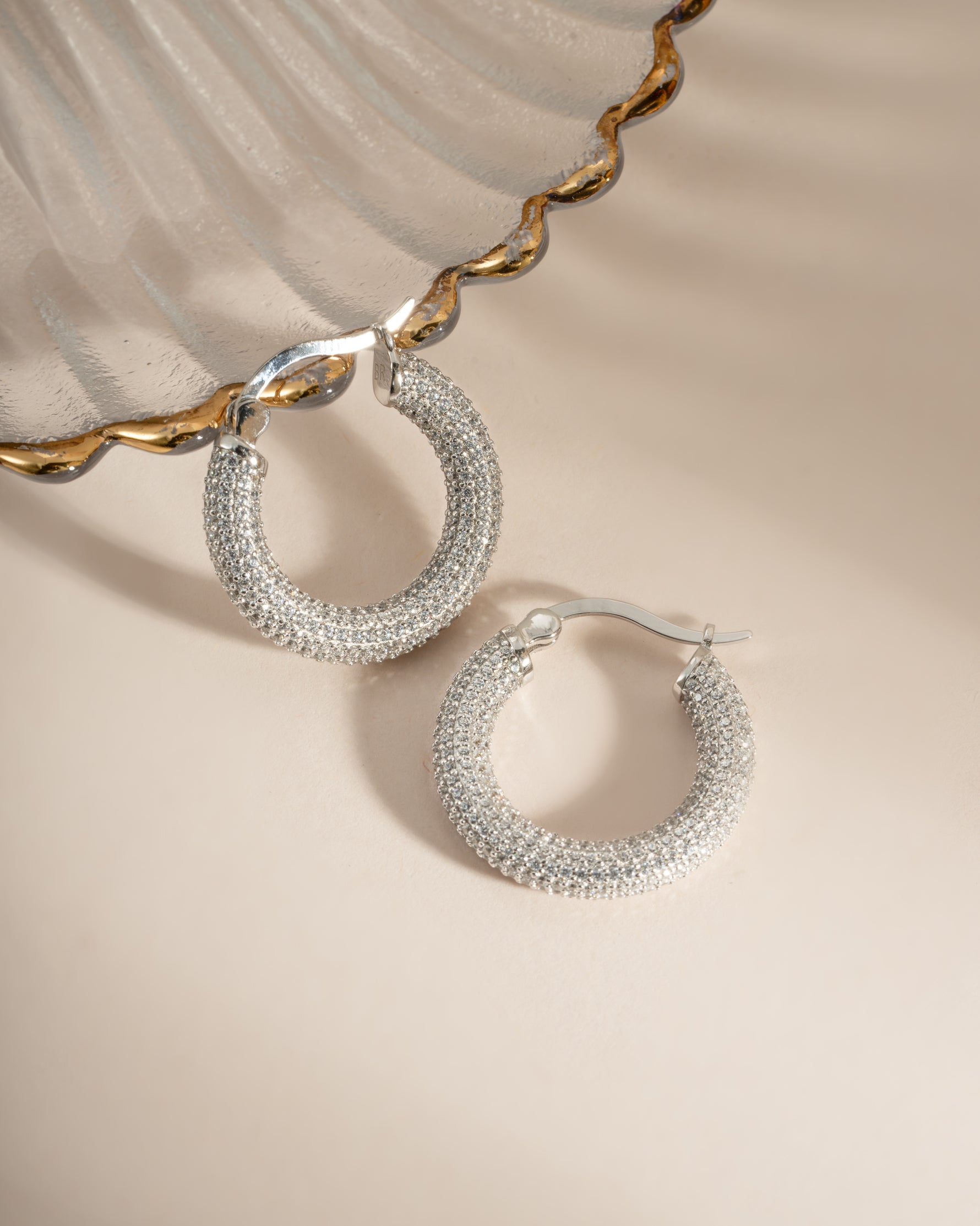 Close-up of sterling silver Pavé Tube Hoops earrings by Sami Jewels, showcasing their sparkling pave design and sleek hoop shape.