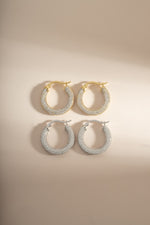 Sterling silver and gold Pavé Tube Hoop Earrings by Sami Jewels, featuring sparkling pavé-set details on sleek hoop designs.