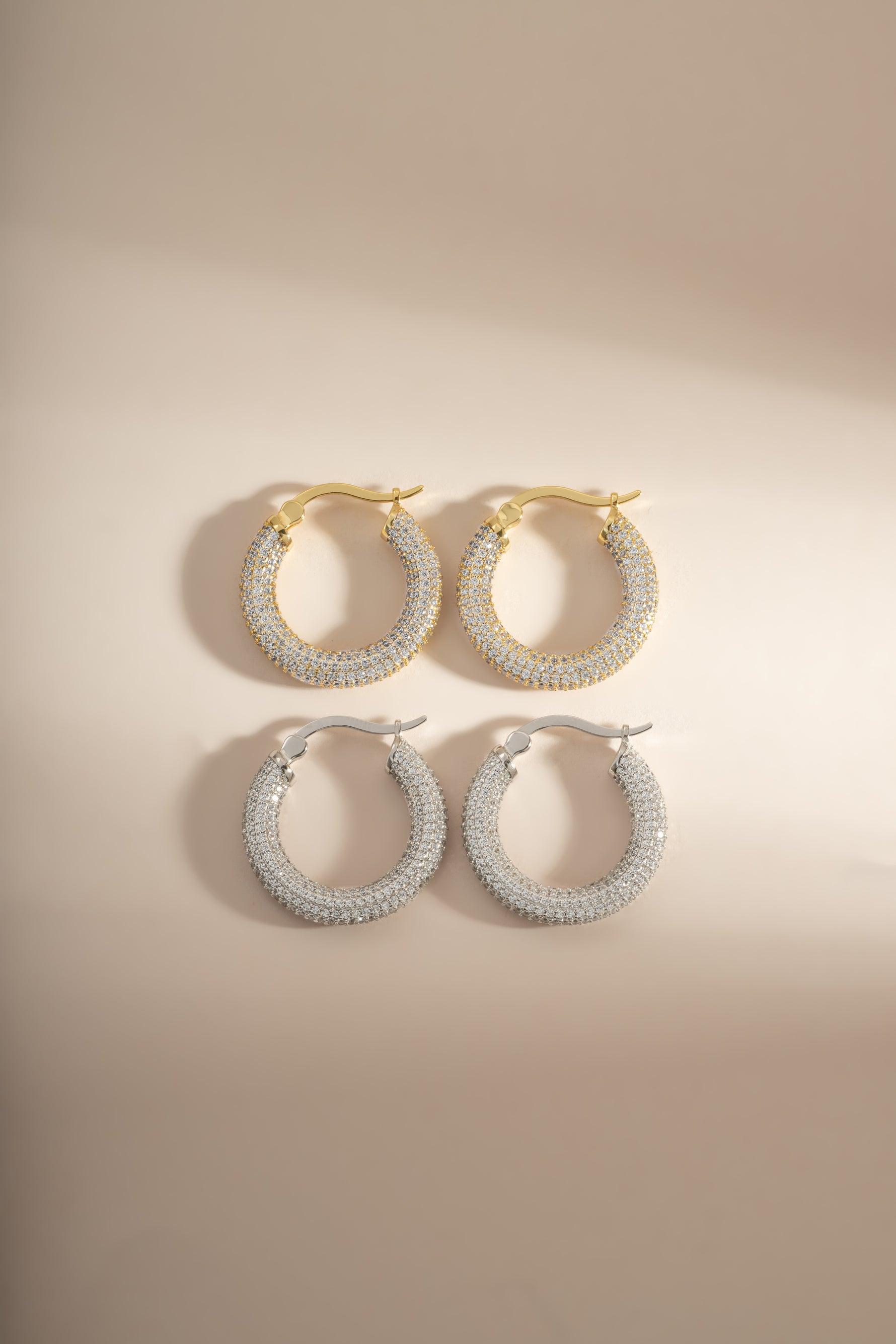 Sterling silver and gold Pavé Tube Hoop Earrings by Sami Jewels, featuring sparkling pavé-set details on sleek hoop designs.