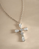 Close-up of Sami Jewels sterling silver pear-cut cross necklace showing detailed craftsmanship and elegant design.
