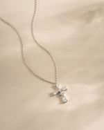 Sterling silver pear cut cross necklace from Sami Jewels, featuring a elegant pendant design displayed on a chain.