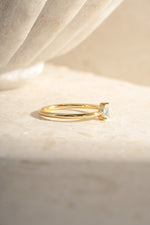 Gold pear-shaped ring from Sami Jewels, side view showing the elegant pear-cut design and smooth band.