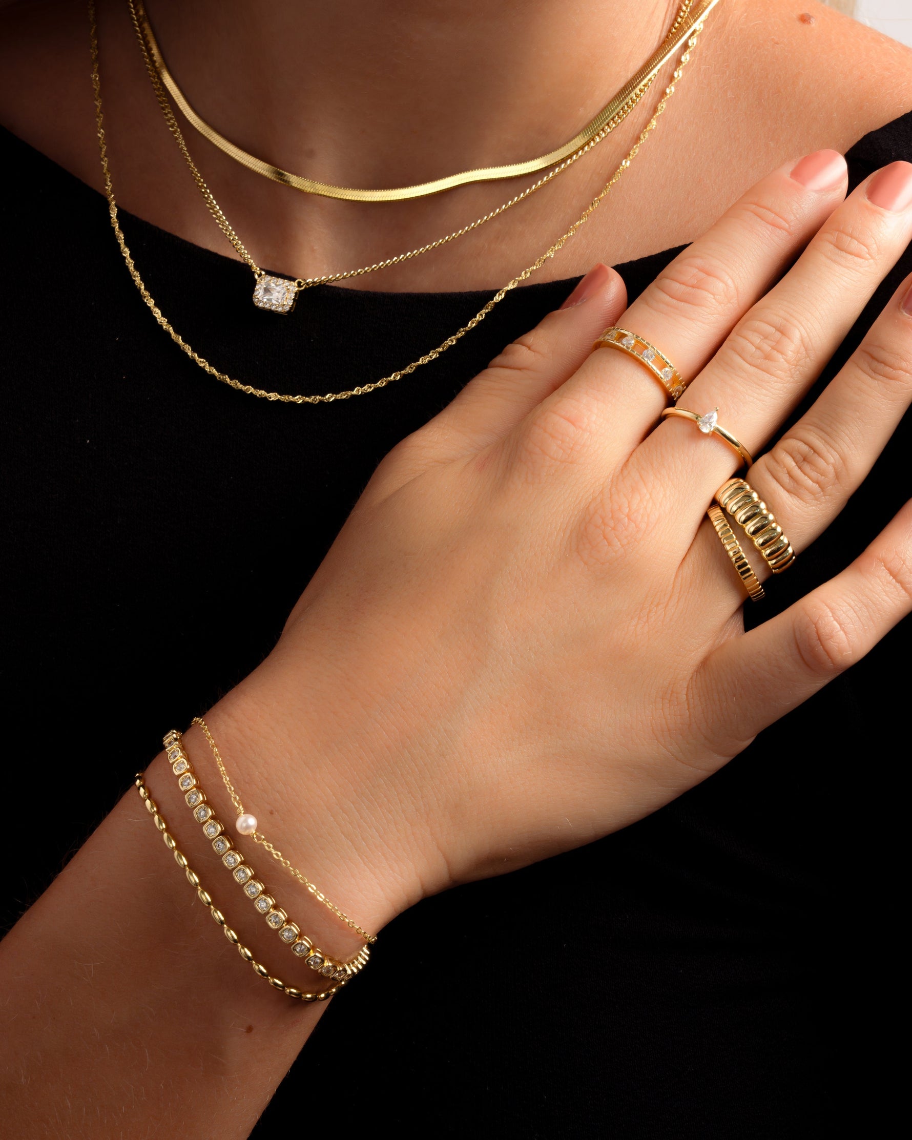 Gold pear-shaped ring from Sami Jewels styled on a model, showcasing elegant jewelry design and craftsmanship.
