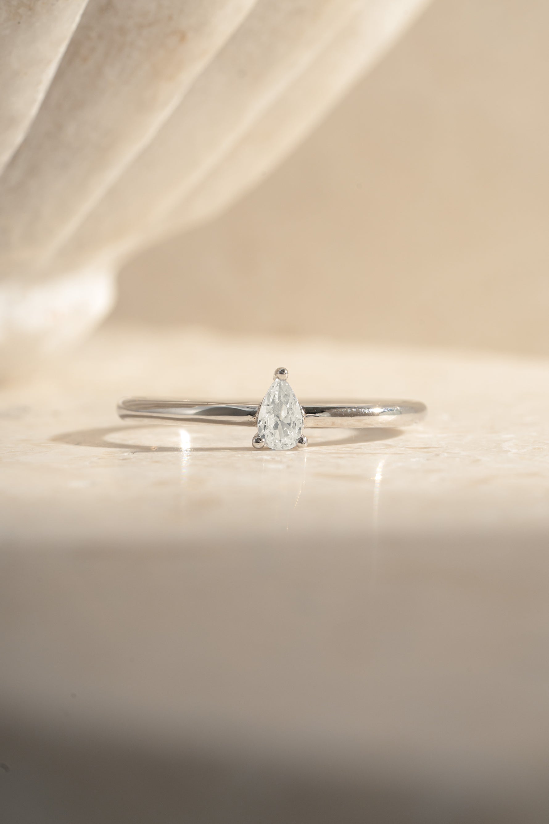 Sterling silver pear-shaped ring by Sami Jewels featuring a smooth, polished design for elegant wear.