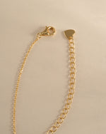 Gold tear drop pendant necklace with a pear-shaped diamond, featuring a lobster clasp closure by Sami Jewels.