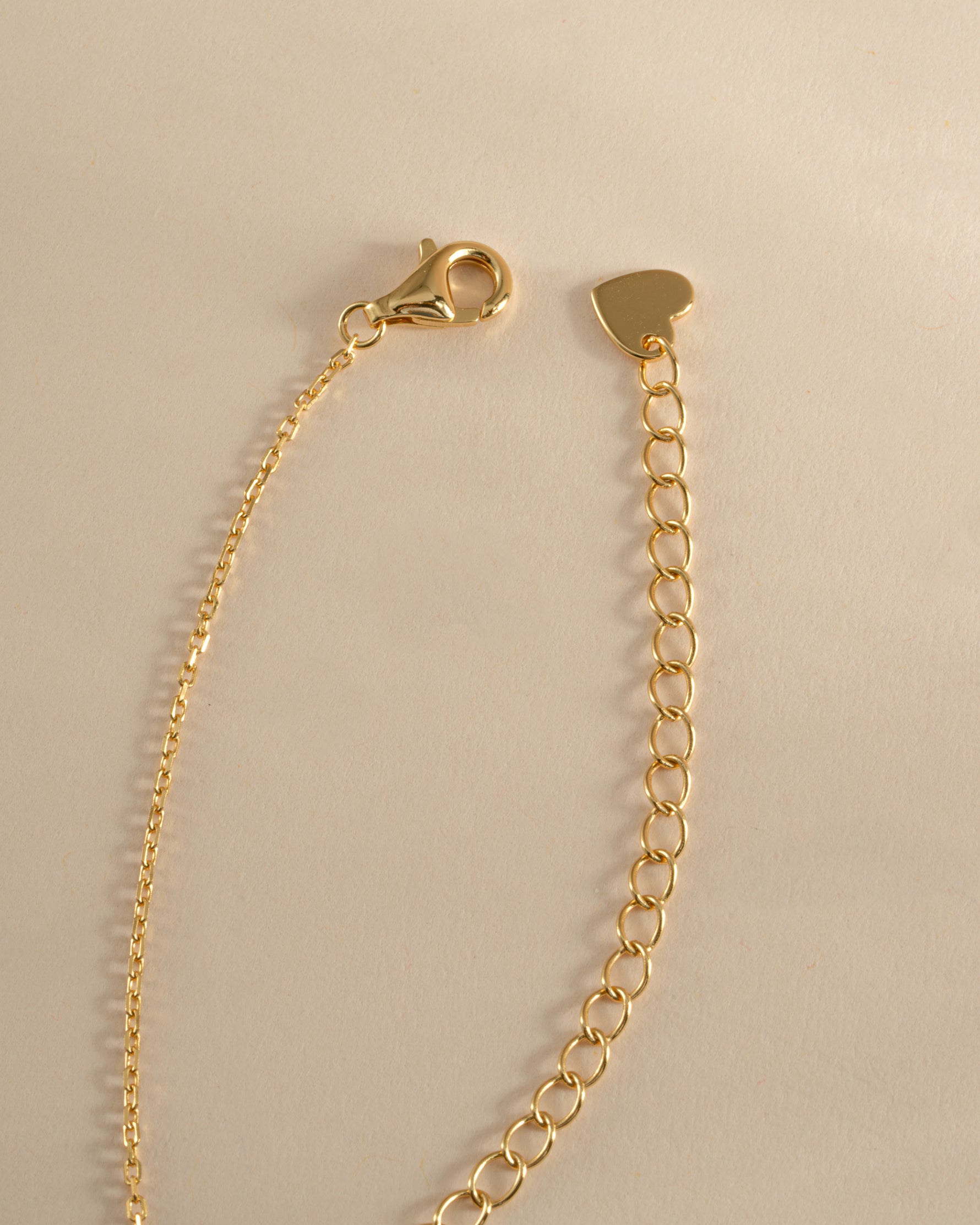 Gold tear drop pendant necklace with a pear-shaped diamond, featuring a lobster clasp closure by Sami Jewels.