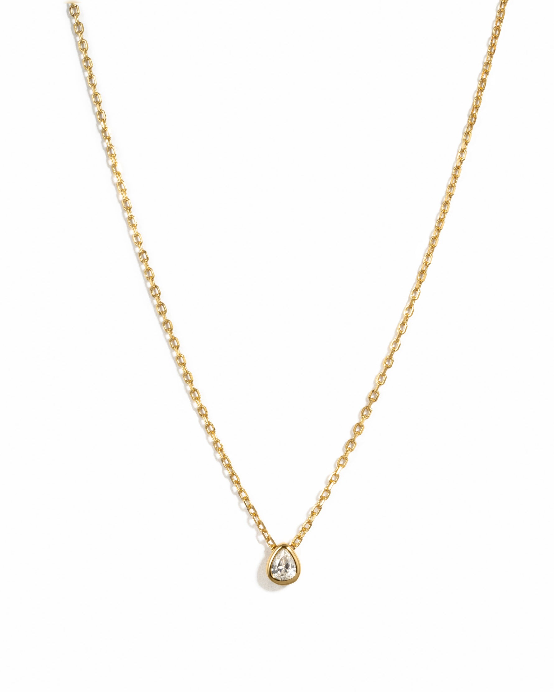 Sami Jewels tear drop pendant necklace featuring a pear-shaped diamond on a gold chain against a white background.