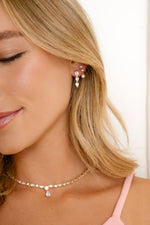 Gold pear drop earrings from Sami Jewels featuring elegant, elongated teardrop shapes on a sleek earring design.