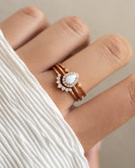 Sami Jewels Pear Opal Ring Set featuring elegant rose gold rings with pear-shaped opal gemstones on a model's hand.