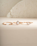 Set of three Sami Jewels pear opal rings in rose gold, featuring elegant gemstone designs and intricate band details.