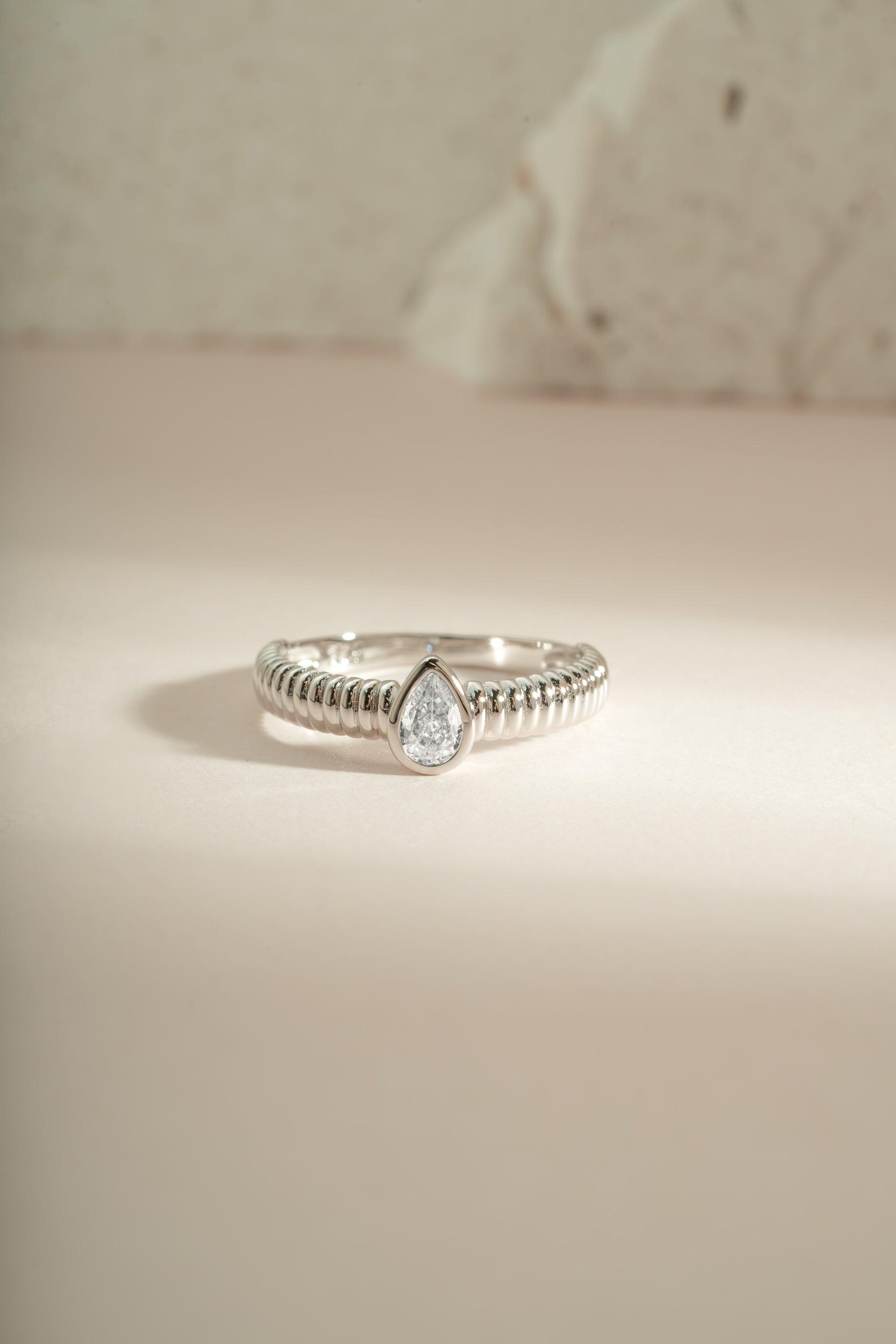 Close-up of Sami Jewels Pear Statement Ring featuring a sterling silver pear-shaped design on a sleek band.