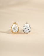 Gold and sterling silver tiny pear-shaped stud earrings by Sami Jewels, close-up of minimalist jewelry accessory.