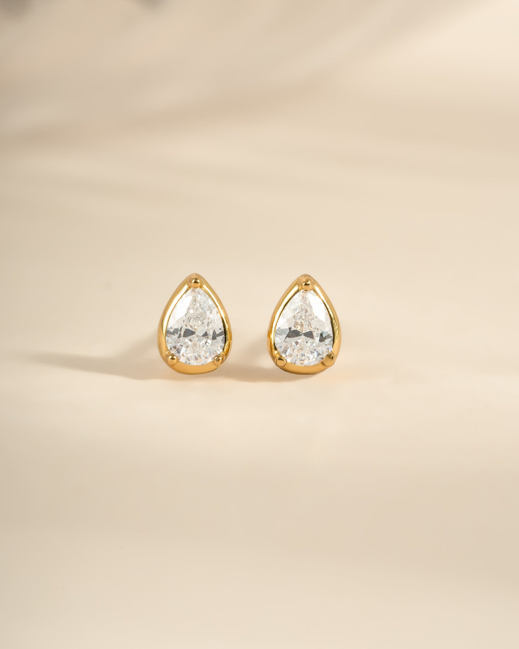 Gold Tiny Pear Stud Earrings from Sami Jewels, front view showing small, elegant pear-shaped design in a close-up image.