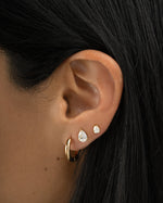 Gold Tiny Pear Stud Earrings from Sami Jewels worn on a model, showcasing small, elegant pearl-shaped jewelry.