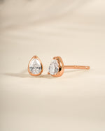Gold Tiny Pear Stud Earrings by Sami Jewels, small dainty pearl-shaped earrings on a white background.