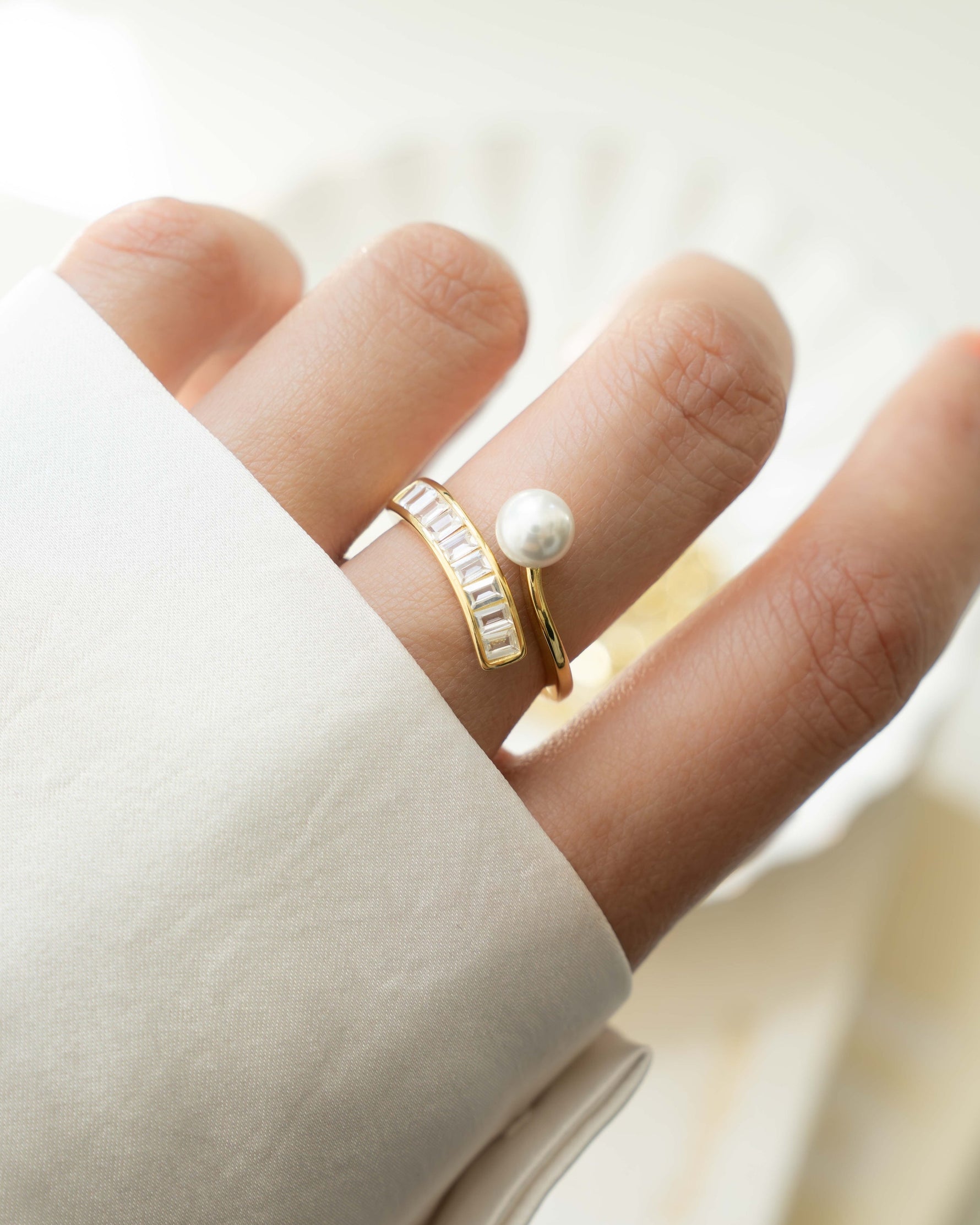 Gold Pearl Baguette Ring by Sami Jewels featuring a central pearl set in a sleek baguette design.