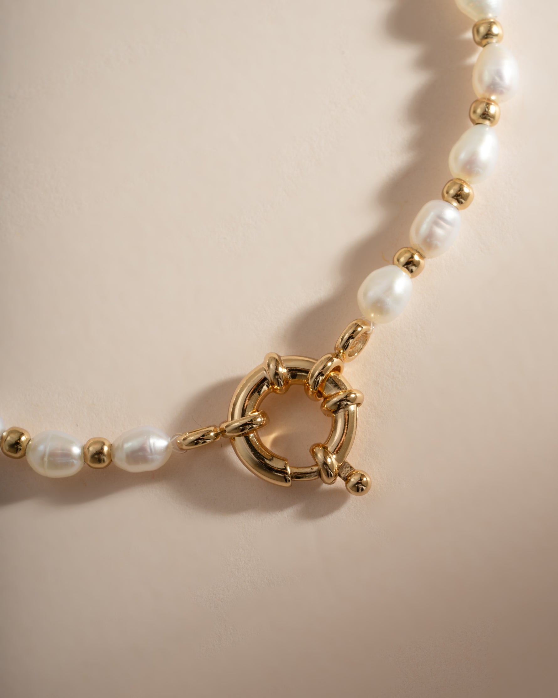 Close-up of Sami Jewels pearl beaded bracelet with gold accents, showcasing elegant jewelry design and fine craftsmanship.