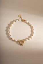 Beaded pearl bracelet from Sami Jewels featuring white pearls and gold accents, stylish and elegant jewelry accessory.