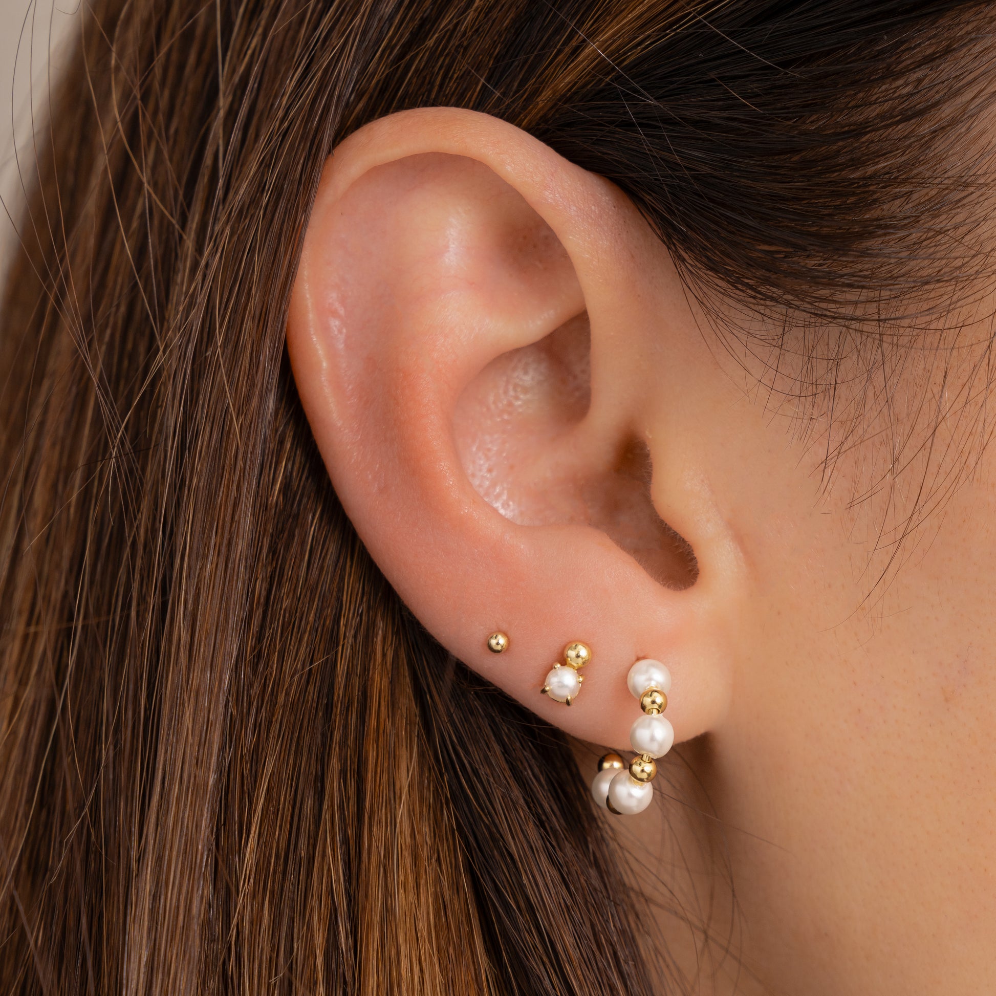 pearl hoop earrings paried with pearl studs 