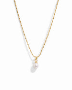 Gold pearl pendant necklace from Sami Jewels with a single white pearl on a delicate chain, displayed against a white background.