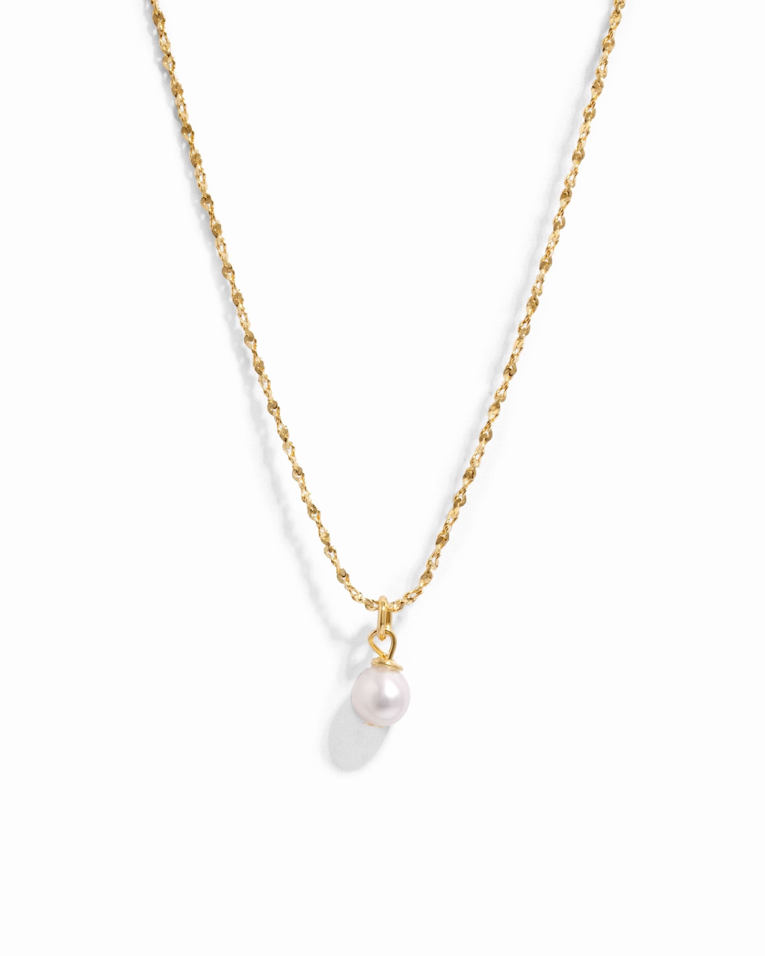Gold pearl pendant necklace from Sami Jewels with a single white pearl on a delicate chain, displayed against a white background.