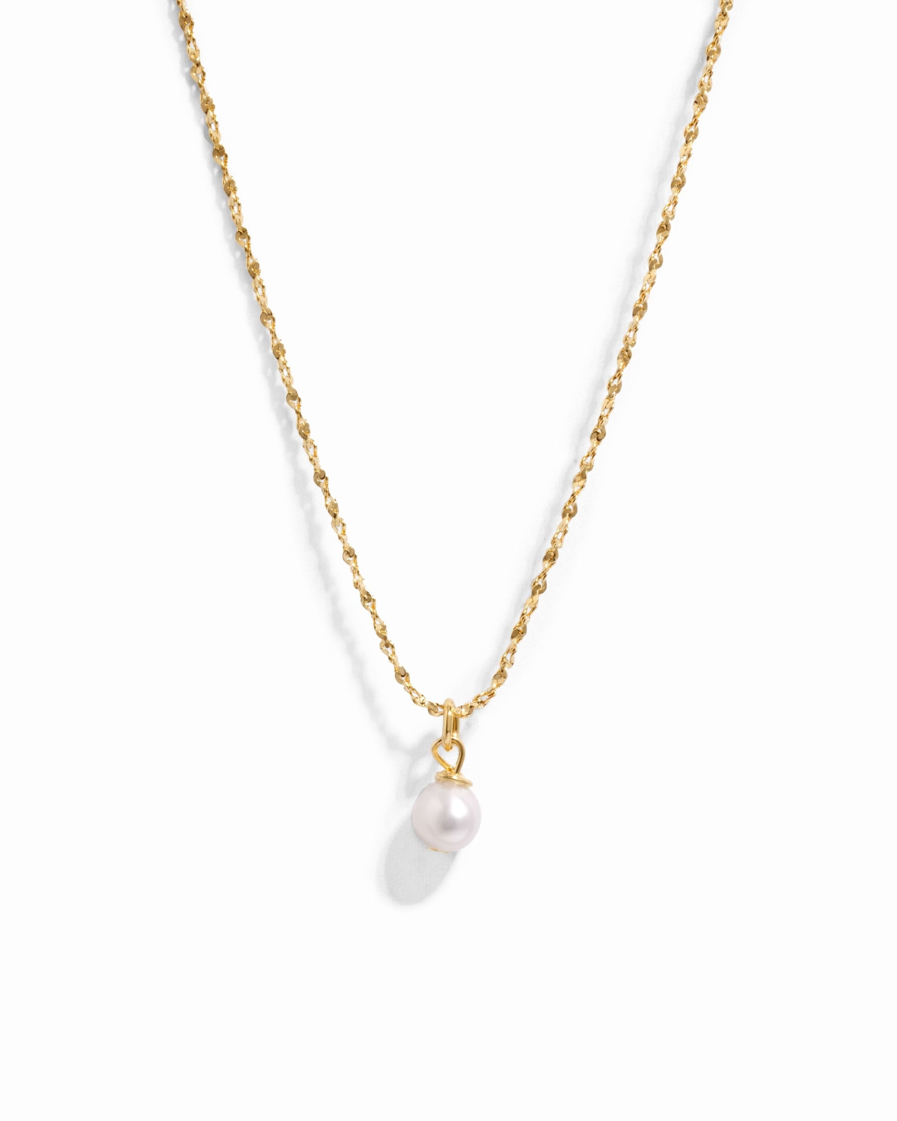 Gold pearl pendant necklace from Sami Jewels with a single white pearl on a delicate chain, displayed against a white background.