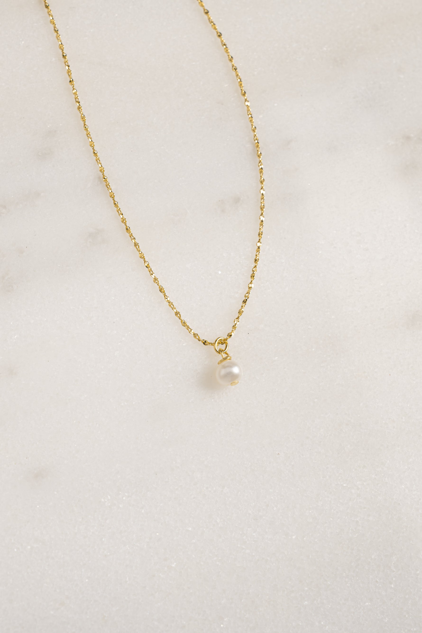 Gold pearl pendant necklace from Sami Jewels featuring a classic round pearl on a delicate chain.
