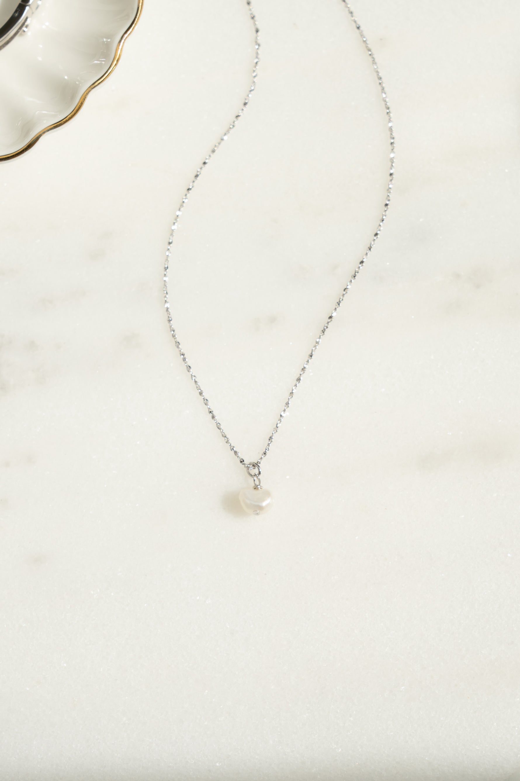 Sterling silver pearl pendant necklace from Sami Jewels featuring a single lustrous pearl hanging on a delicate chain.