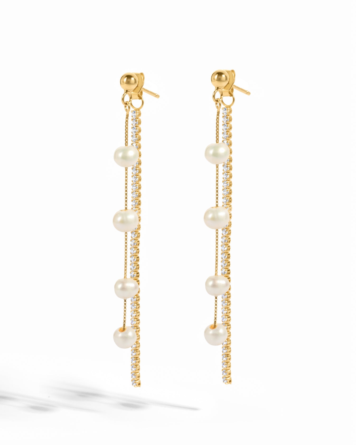 Gold dangling bead pearl earrings with tassels from Sami Jewels, featuring white pearls and intricate gold detailing.