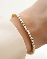 Gold stainless steel SS Pearl Tennis Bracelet by Sami Jewels featuring elegant freshwater pearls on a sleek bracelet.