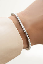Sami Jewels SS Pearl Tennis Bracelet featuring white pearls and stainless steel design, waterproof and elegant for everyday wear.
