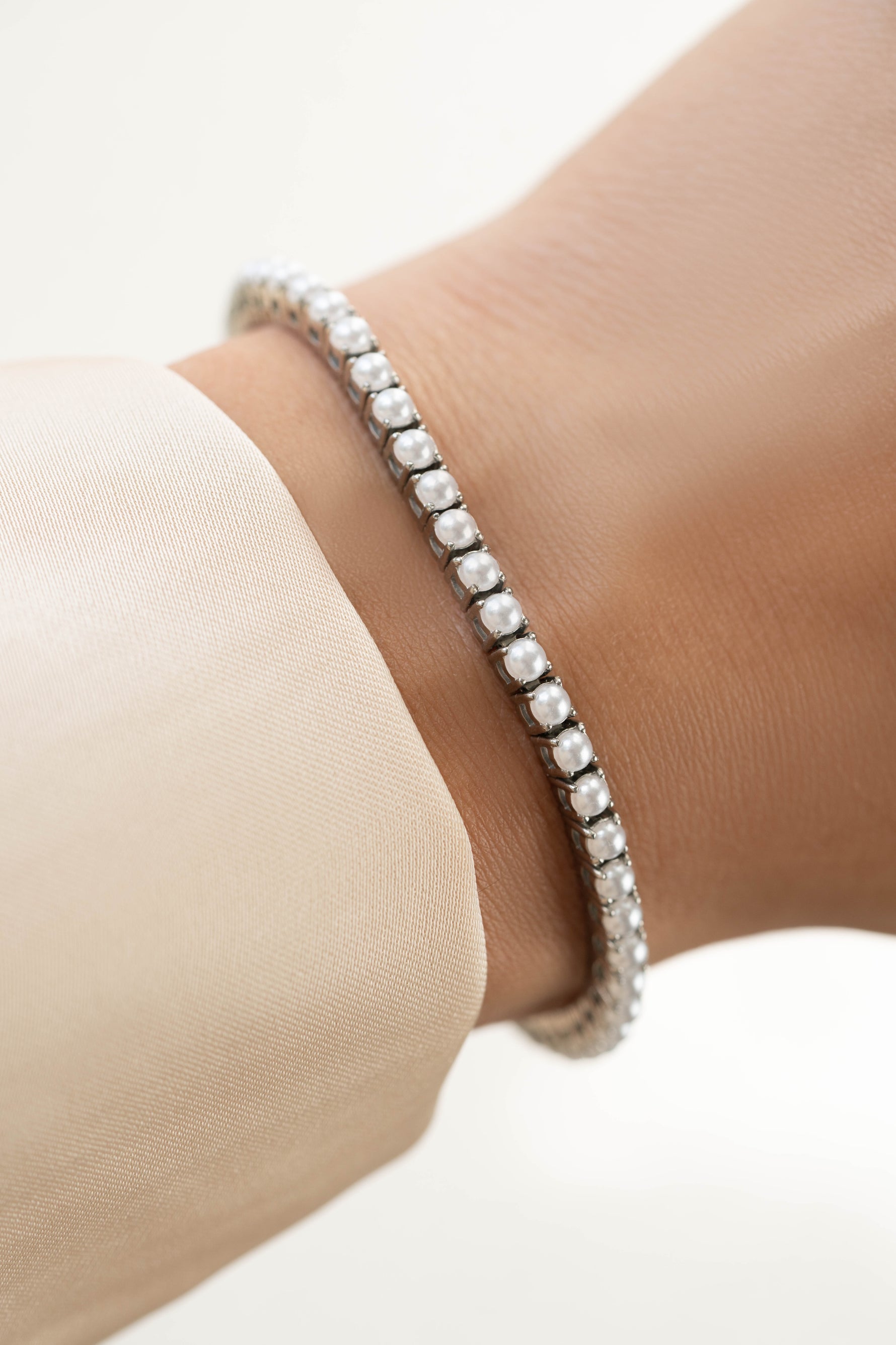 Sami Jewels SS Pearl Tennis Bracelet featuring white pearls and stainless steel design, waterproof and elegant for everyday wear.