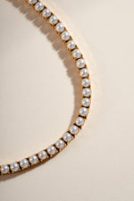 Close-up of Sami Jewels SS Pearl Tennis Necklace with gold stainless steel chain and sparkling white pearls.
