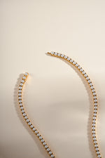 Gold stainless steel SS Pearl Tennis Necklace by Sami Jewels featuring waterproof closure and elegant pearl design.