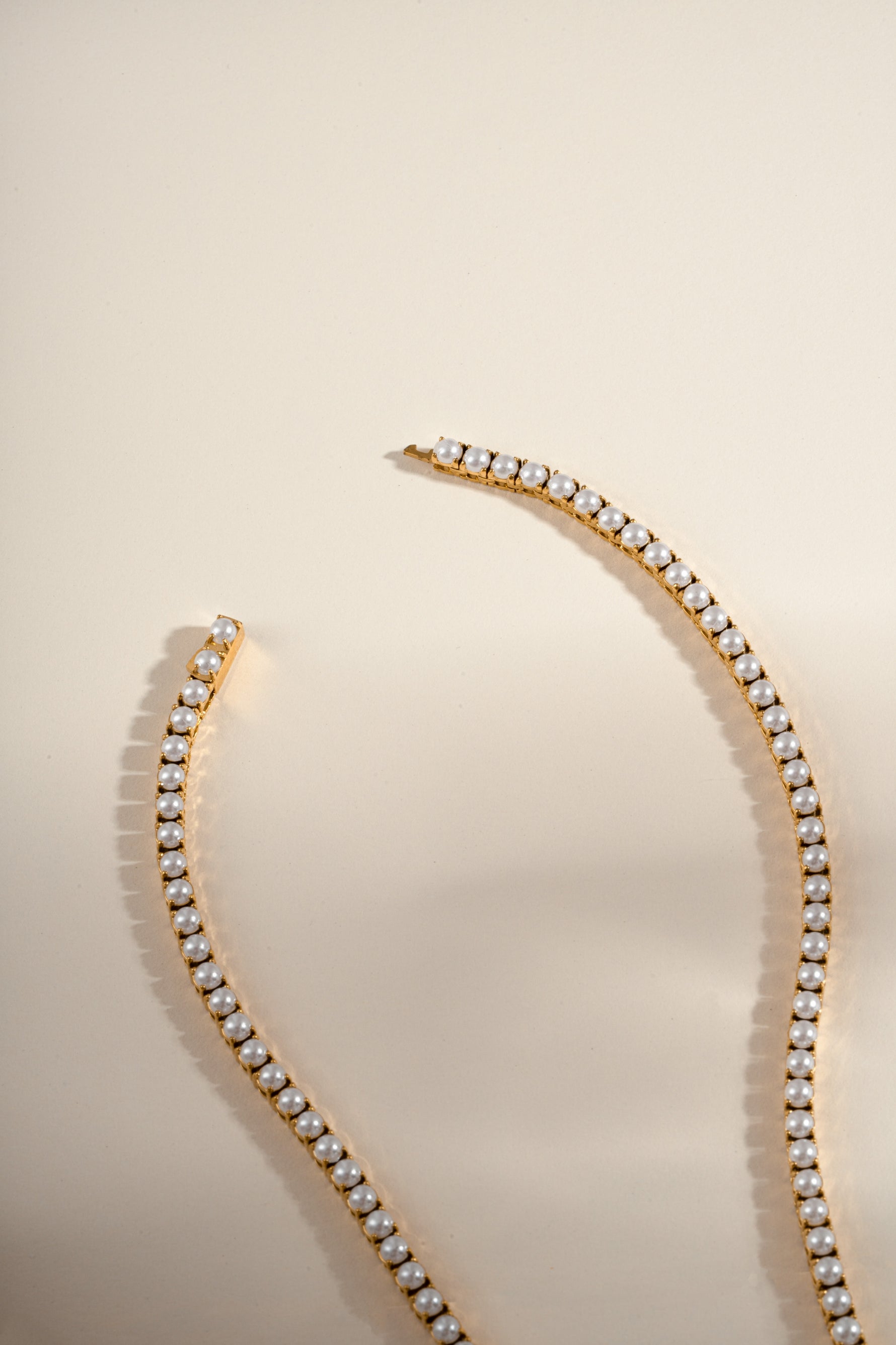 Gold stainless steel SS Pearl Tennis Necklace by Sami Jewels featuring waterproof closure and elegant pearl design.