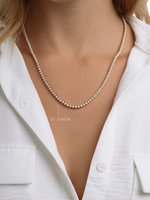Gold stainless steel SS Pearl Tennis Necklace by Sami Jewels featuring a string of white pearls on a sleek, waterproof design.