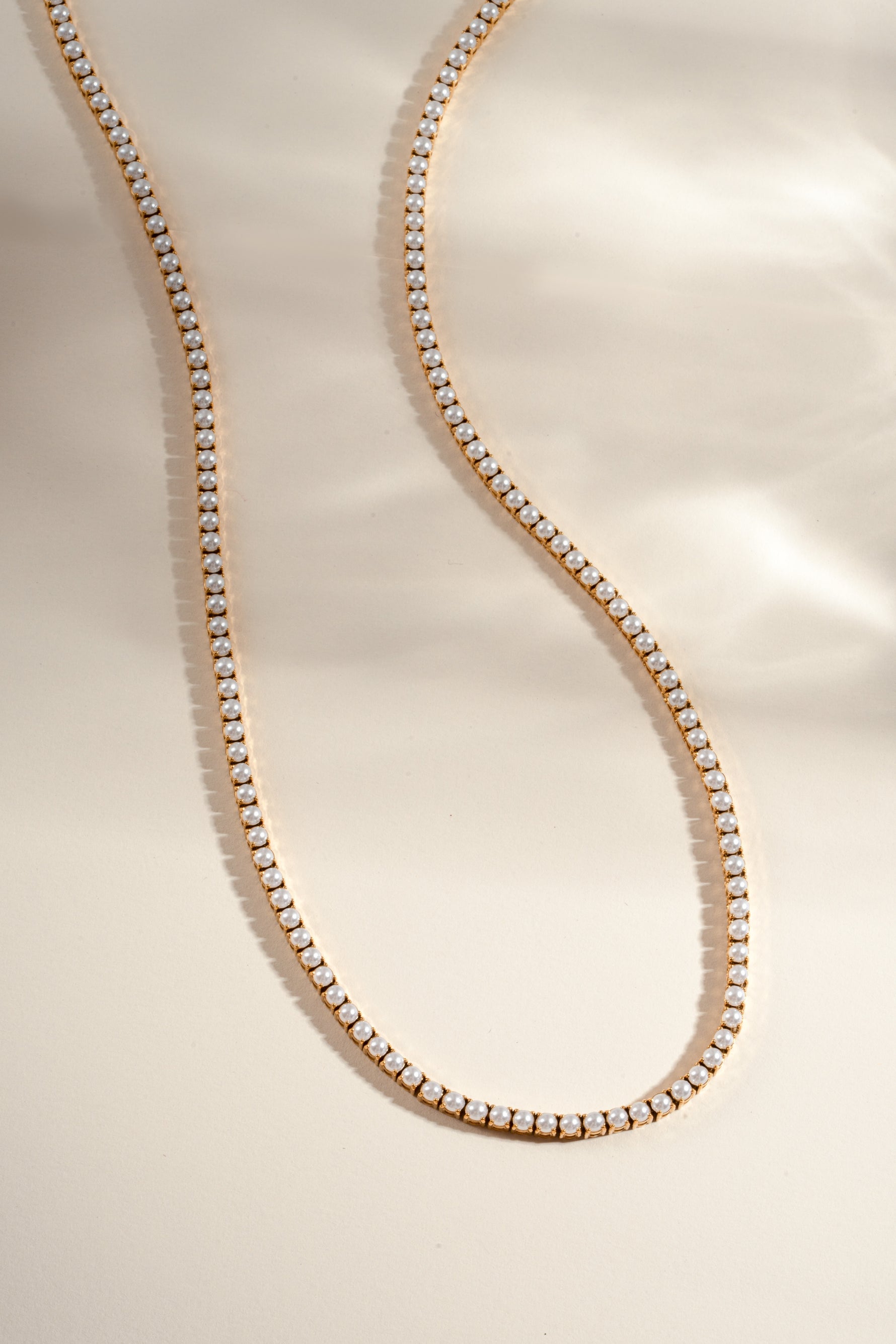 Gold stainless steel SS Pearl Tennis Necklace by Sami Jewels featuring a row of lustrous pearls on a sleek chain.