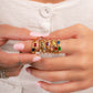 Baguette birthstone rings stacked on model's finger. 
