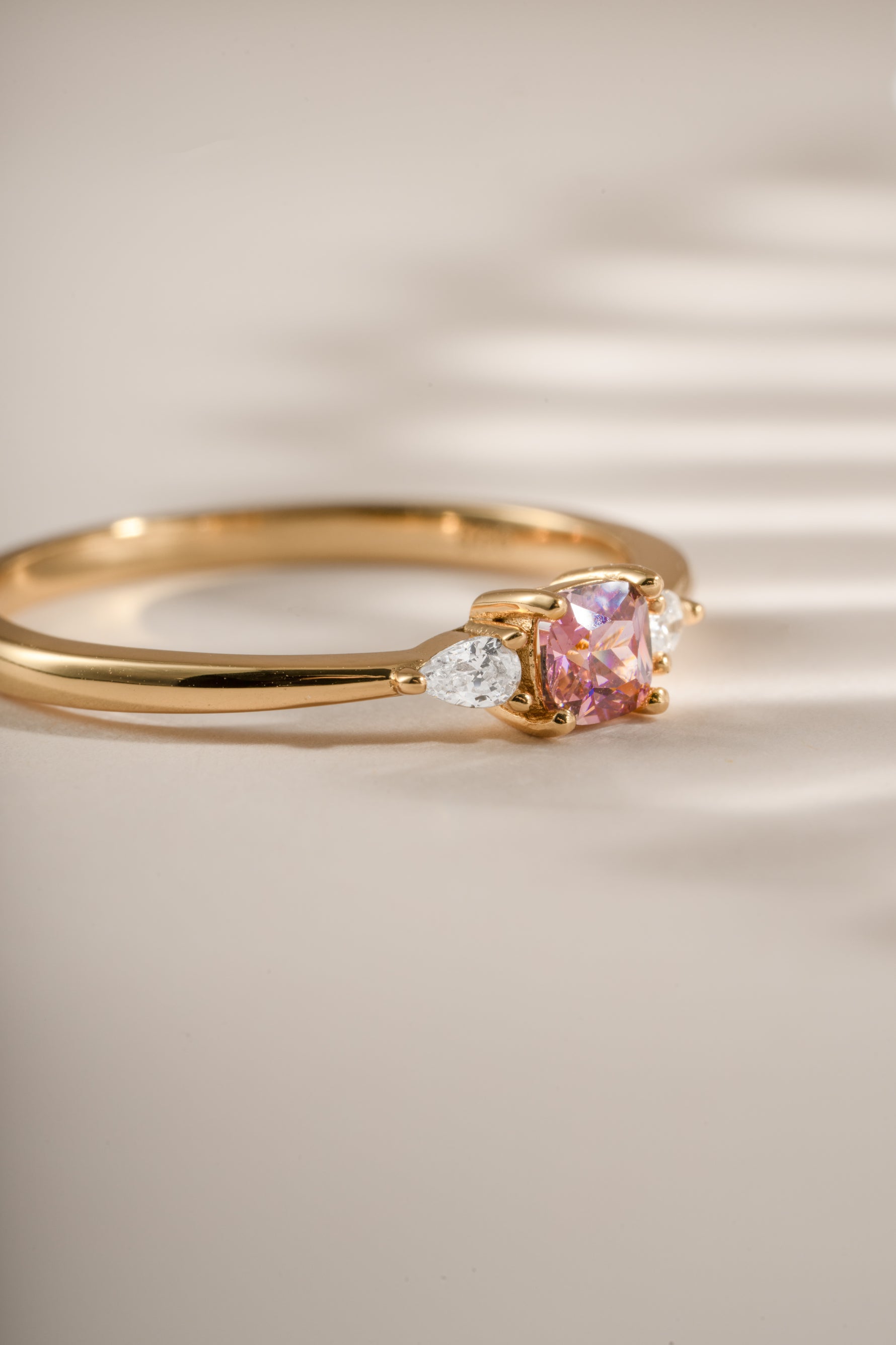Close-up of Sami Jewels pink cushion ring with gold band, showcasing its vibrant pink gemstone and elegant design.