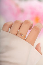 Pink cushion ring by Sami Jewels featuring a gold band and a pink cushion-shaped gemstone.