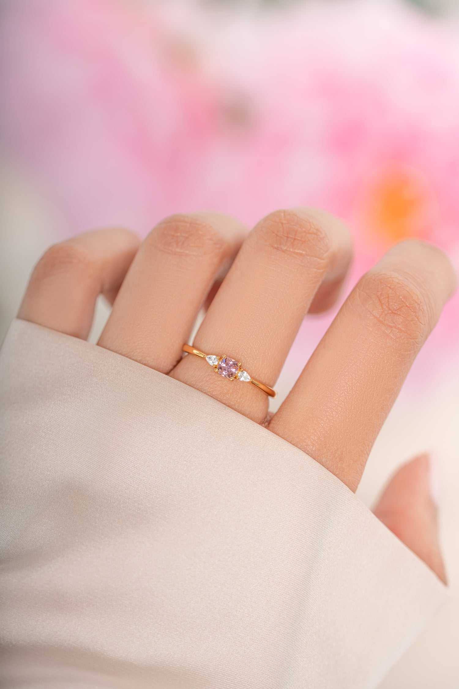 Sami Jewels pink cushion ring featuring a gold band, showcasing a vibrant pink gemstone in a classic cushion shape.