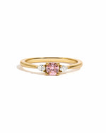 Pink cushion ring by Sami Jewels featuring a gold band, displayed on a white background.