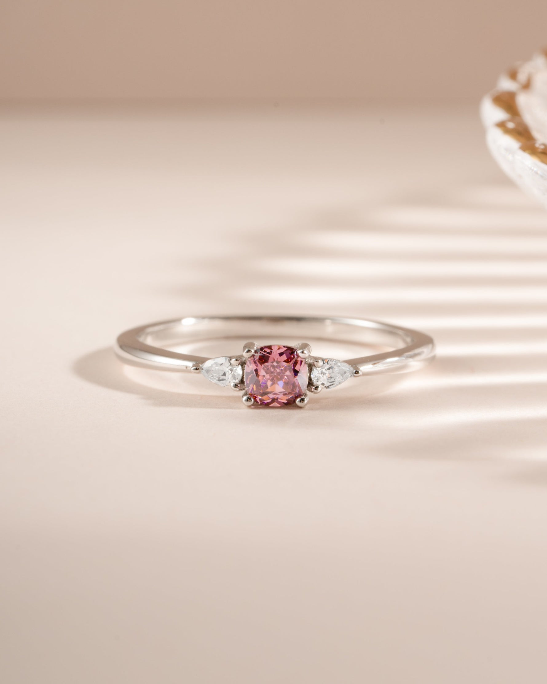 Pink cushion ring by Sami Jewels featuring a sterling silver band and a pink cushion-shaped gemstone.